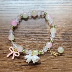 Pink and White Beaded Bracelet with Bow Charm